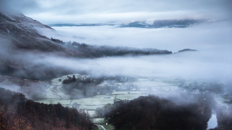 View of the village of Grange with low cloud covering from Castle Crag in winter, Borrowdale, Cumbria
